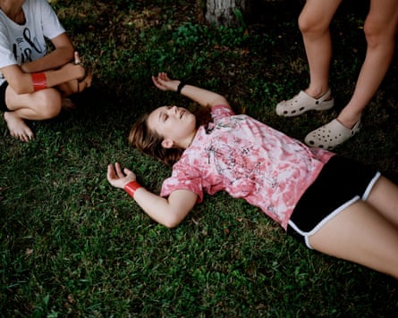 Yelyzaveta lies down for a break on some grass