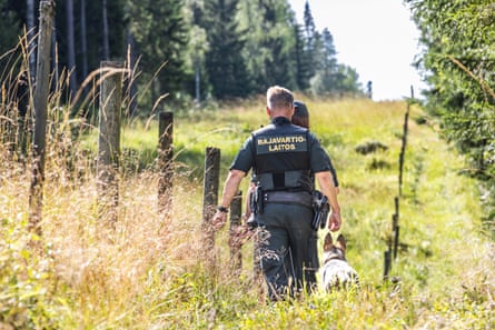 Two people and a dog at the border.