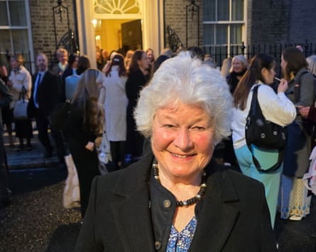 Rosemary Duckett in front of a group of people milling around outside 10 Downing Street.