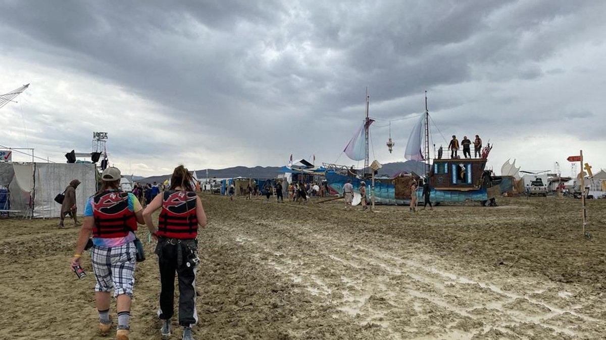 People walk around the Burning Man festival in 2023