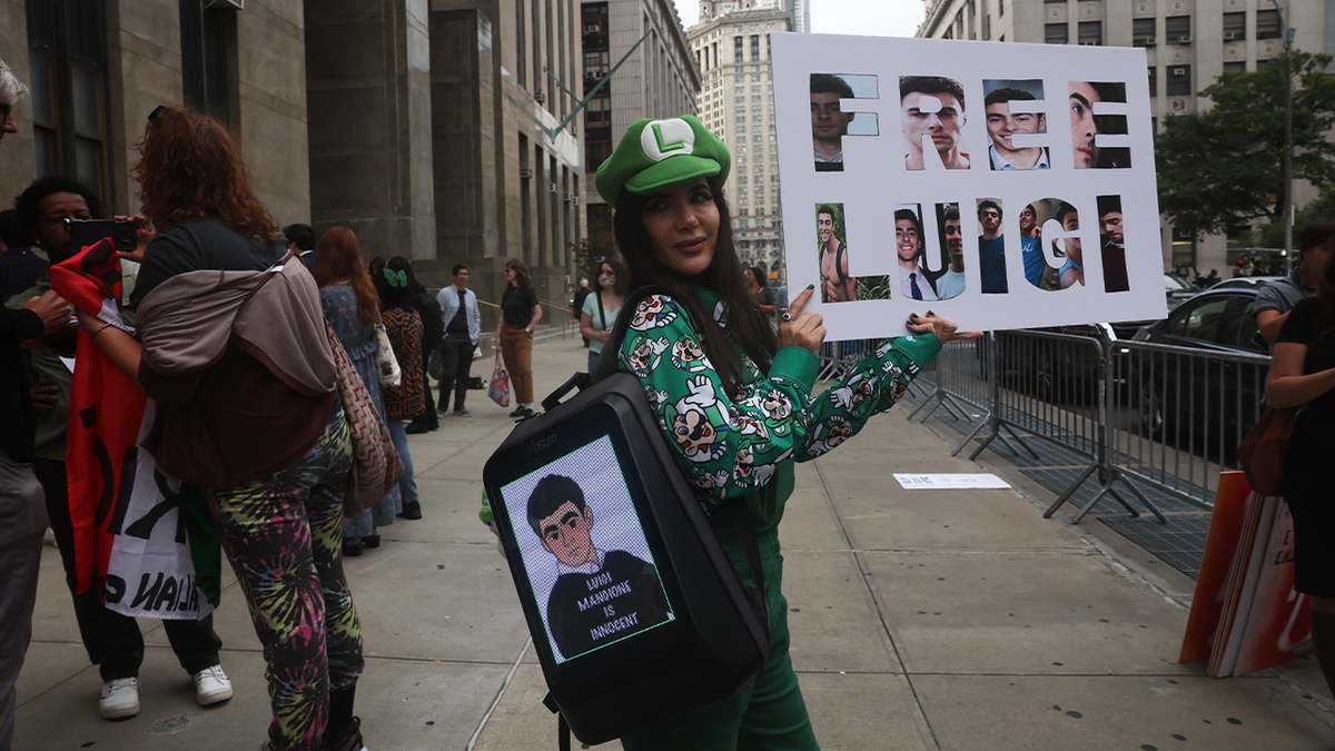 A woman dressed up as the character Luigi from