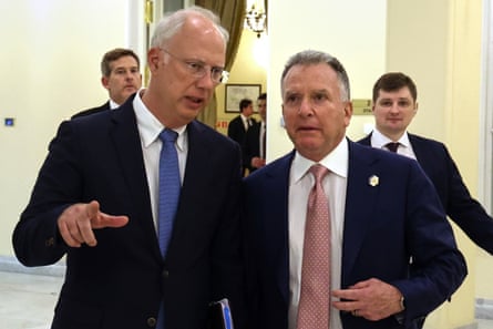 Two men in suits in animated discussion