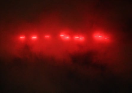 Tracer rounds shoot through the sky 