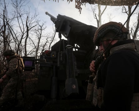 Ukrainian troops prepare to fire a self-propelled howitzer towards Russian forces near the frontline town of Pokrovsk