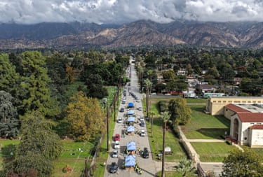 Motorists queue up on a road in California with mountains in the background