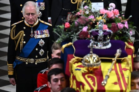 Britain’s King Charles III (L) walks beside the coffin of his mother, Queen Elizabeth II, draped in a Royal Standard and adorned with the Imperial State Crown and the Sovereign’s orb and sceptre as it leaves Westminster Abbey  in London, UK, September 19 2022
