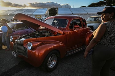 A person looks at a vintage car