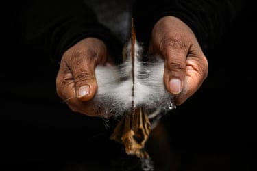 A pair of hands work with wool