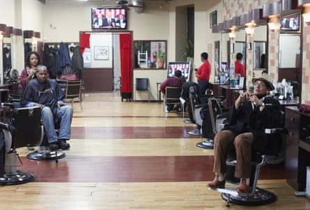 Customers at Denny Moe's Superstar Barbershop in Harlem watch Obama’s state of the union speech in January 2012.