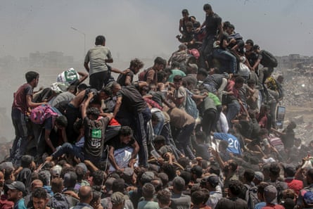 This picture by Mohammed Saber is one of the finalists in the World Press Photo awards. It shows Palestinians climbing on to an aid truck as it enters the Gaza Strip in July 2025.