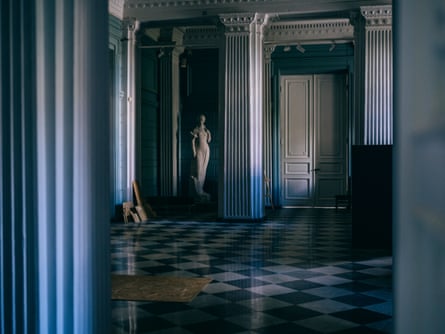 A statue inside a museum in Ukraine with a shiny marble floor 