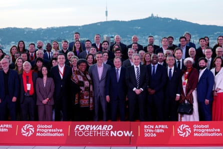 Large number of people stand behind a big sign that says ‘Forward together now’