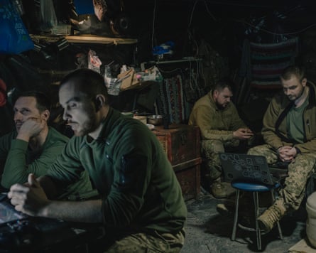 Soldiers from the 148th artillery brigade, sitting in an underground bunker