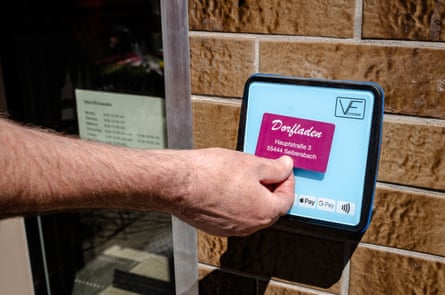 A person tapping an electronic access pass on a screen.
