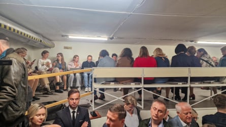 People gather inside a shelter at the Lithuanian parliament after the ‘air danger’ warning.