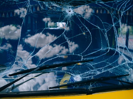 A bus with a damaged front window.