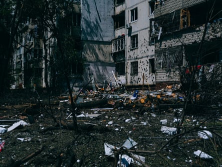 Rubble and branches on the ground outside a building.