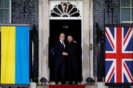 Starmer and Zelenskyy embrace outside No 10 with Ukraine and UK flags either side of door