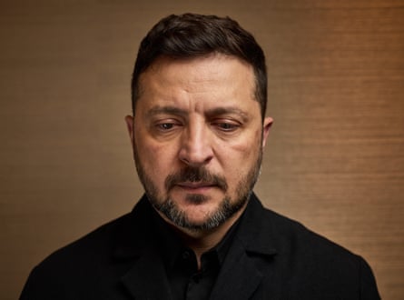 Zelenskyy facing towards the camera, looking down to the ground