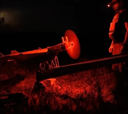 A drone taking off from a rail at night.