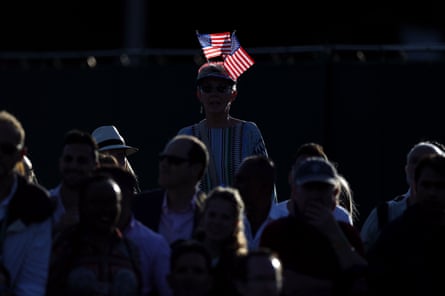 a woman wears two US flags on her hat