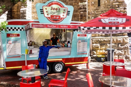 people stand at a food truck