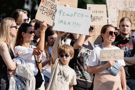Protesters hold a rally with posters calling for peace