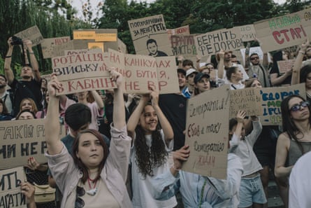 A group of protesters holding placards written in Ukrainian