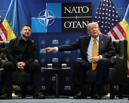 Donald Trump and Volodymyr Zelenskyy sit on leather chairs in front of US and Ukraine flags