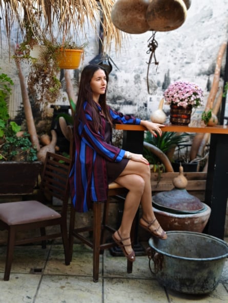 Margarita Reutt sits on a stool in a posed photograph.