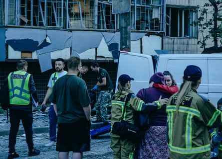 Emergency workers and civilians after a Russian attack on Solomyanskiy district