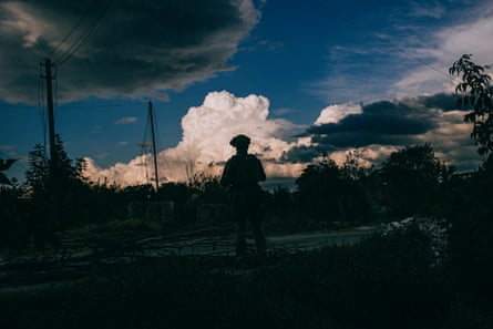 The silhouette of Young against a cloudy sky.