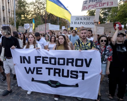 Young people march behind a white banner with the words ‘In Fedorov we trust’