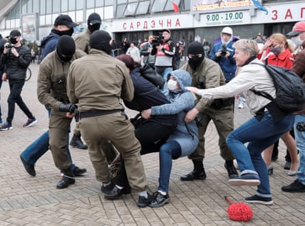 Law enforcement officers drag a demonstrator during an opposition rally in Minsk in 2020.