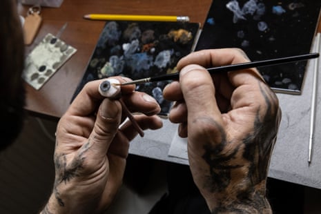 A person’s hands using a paintbrush on a 3D printed eye