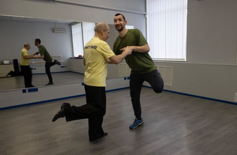 Andriy Onopriienko dances with a partner in a studio