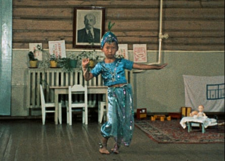 A young boy in traditional costume dancing