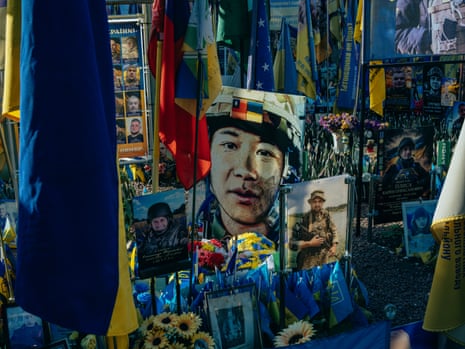 Memorial to Peng, with photographs, flowers and flags