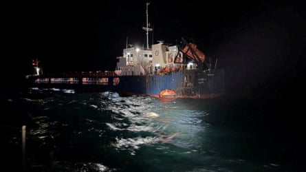 A damaged vessel at night.