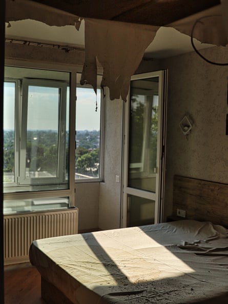 A damaged hotel room with bits of the ceiling falling down.