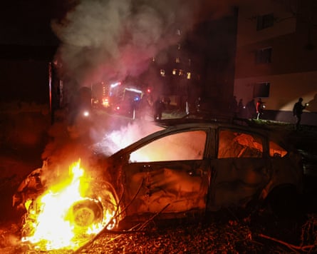 A car burns after a Russian airstrike on a residential neighborhood in Zaporizhzhia.