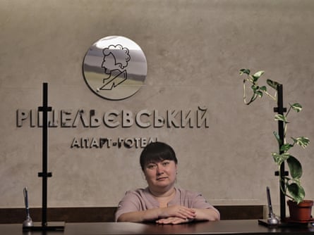 A woman sitting behind a hotel reception desk