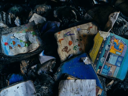Charred and soggy remains of children’s picturebooks illustrated with animals and flowers
