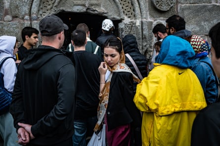 A worshipper exits Gergeti Trinity Church after prayer during the festival.