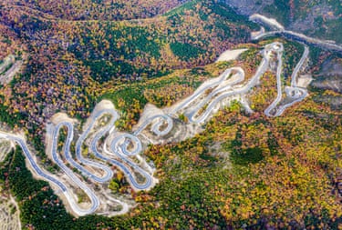 Aerial view of the winding Taihang No 1 tourist highway curving through autumnal woods
